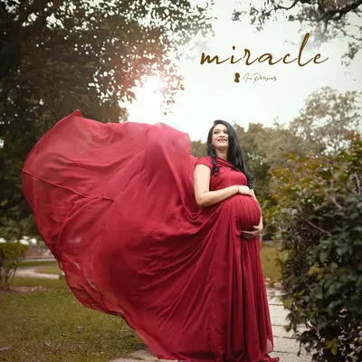 A magical maternity shoot moment. The client is wearing a flowing red gown, and I created a soft, natural makeup look to match the dreamy vibe.