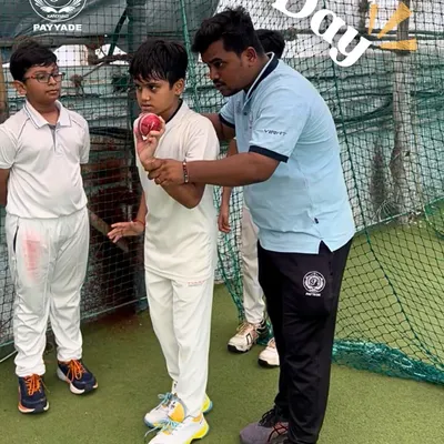 The foundation of great cricket is a perfect technique. Here, one of our coaches provides personalized guidance to a young bowler, carefully adjusting his grip on the ball to ensure the correct seam position for effective spin. This hands-on approach is central to our guru-shishya coaching philosophy.