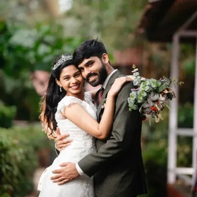 A classic, romantic portrait from a Goa wedding. The soft natural light and lush green background create a serene setting for this simple, affectionate embrace.