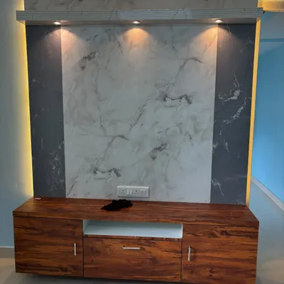 A closer look at a modern TV unit with a marble-finish back panel and a rich wooden console. The focused spotlights highlight the textures, while the side panels add depth to the design.