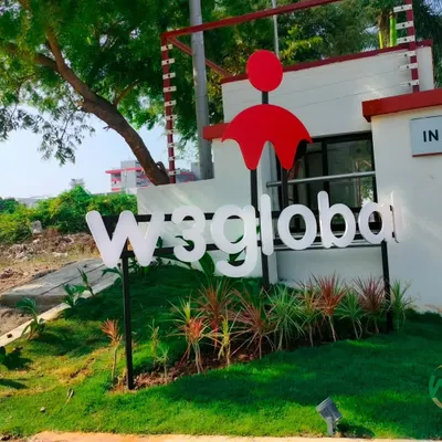 The entrance of W3global's office at SIPCOT IT Park, featuring their brand signage integrated into our landscape design. A well-designed entrance makes a strong first impression for any business.