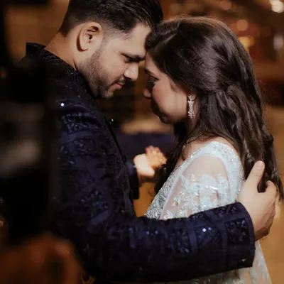 A close-up of the couple in a tender embrace, their foreheads touching. This intimate framing shuts out the world, focusing solely on their connection and the quiet promise they share.