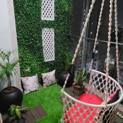 I designed this balcony as a special place for a small child. With a fun macrame swing, soft artificial grass to sit on, and some pebbles to play with, it has become her favorite spot to swing, play, and even have her meals.