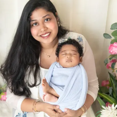 There's nothing like a mother's love. This classic portrait captures a new mom holding her sleeping baby, a timeless image of their special bond.