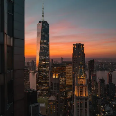 The One World Trade Center stands tall against a fiery sunset over downtown Manhattan. This is one of my favorite views of the city, capturing its resilience and beauty.