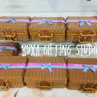 A heartfelt thank you for your bridesmaids. I designed these elegant wicker-style trunks with soft lilac and blush ribbons to hold special gifts for the bride's forever girls.