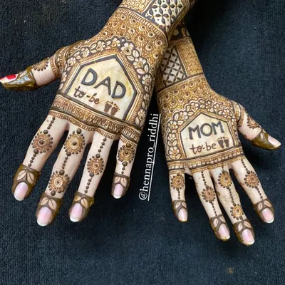 Matching henna for the parents-to-be is such a sweet idea. This design features 'Mom to be' and 'Dad to be' with tiny baby footprints, creating a beautiful memory of this special time.