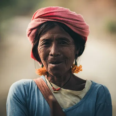 A warm, intimate portrait of an elderly woman with a gentle smile, showcasing the ability to capture character and emotion in environmental portraiture.