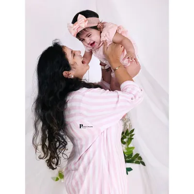 A candid, joyful moment as a mother lifts her baby girl. We love capturing these spontaneous interactions that show the true happiness of motherhood.