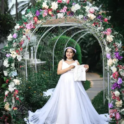 This is the complete fairytale experience I create for my maternity clients. The package for this look includes the flowing white rental gown, a delicate floral crown, professional makeup, and hairstyling, all set against a beautiful floral arch to perfectly capture the moment.