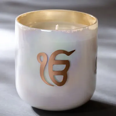 My 'Ek Onkar' spiritual candle is designed for meditative moments. The sacred symbol glows beautifully on the iridescent glass, while the exquisite fragrance facilitates inner peace and clarity. It is a vessel for your scented spiritual practices.