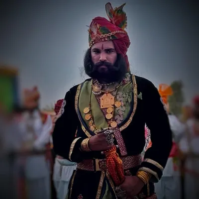 A proud Rajasthani man in traditional attire and a magnificent turban at the Ranakpur Festival, embodying the region's regal heritage.