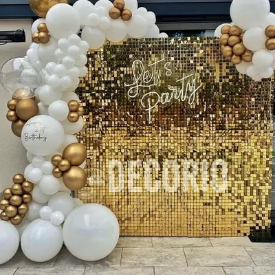 This modern party backdrop features a gold sequin wall that shimmers beautifully in photos. The "Let's Party" neon sign and an elegant white and gold balloon garland complete this high-energy photo booth setup.