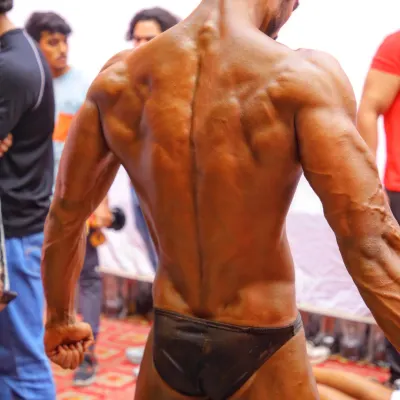 A detailed back shot. This pose shows the separation and density of the spinal erectors, lats, and traps, all crucial for a winning back pose.