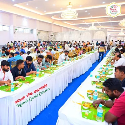 A packed convention hall with guests enjoying our traditional banana leaf meal. We are equipped to handle catering for large wedding receptions with flawless execution.