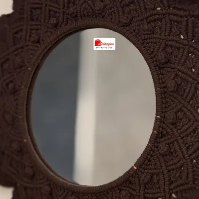 This decorative wall mirror is framed with an intricate, hand-knotted macrame design. Shown here in a rich brown, it adds a beautiful, textural element to any wall and is available at a special discounted price.