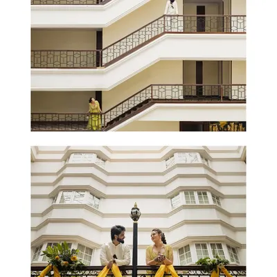 A creative architectural shot of the couple during their Mehendi day, using the building's lines to frame them beautifully.