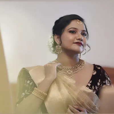 This bride chose a very elegant and classic look for her big day. Her makeup is subtle yet defining, with a classic red lip and a soft updo adorned with fresh white flowers.
