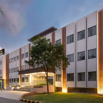 The Jindal Public School in Dabaspet, a project designed to provide free, quality education in a modern campus that rivals private institutions. The facade lighting highlights the architectural details, creating a welcoming beacon for the community at night.