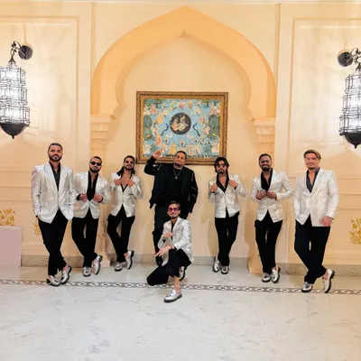 Suited up and ready for the sangeet night. Our team in silver jackets, bringing the style and the beats.