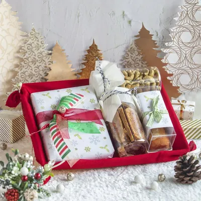 A festive red tray hamper for Christmas, filled with a delightful assortment of cookies, nuts, bar cakes, and other treats. Perfect for gifting or sharing at holiday parties.