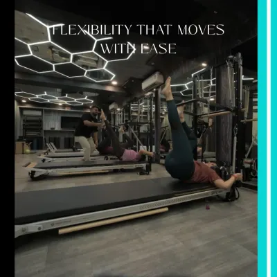 Flexibility that moves with ease. This client is performing a leg stretch on the Reformer, a move that improves hamstring flexibility and requires core control to stabilize the body.
