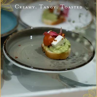 A modern classic, our avocado cream cheese toast is topped with fresh cherry tomato and a cube of paneer. It's a creamy, tangy, and refreshing bite perfect for high-tea or as a welcome appetizer.