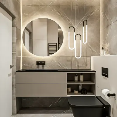 A chic and modern bathroom featuring a floating vanity with open and closed storage. The large, backlit circular mirror and stylish pendant lights add a touch of glamour to the marble-tiled space.