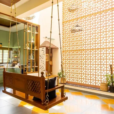 A traditional wooden swing (jhula) is the heart of this living space, set against a backdrop of a double-height jali screen and Jaisalmer marble inlay flooring. This is the essence of my Indian Modern design philosophy.