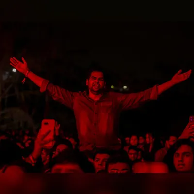 One fan, arms outstretched, feeling the music. This is the personal, almost spiritual connection we aim to create at every concert.