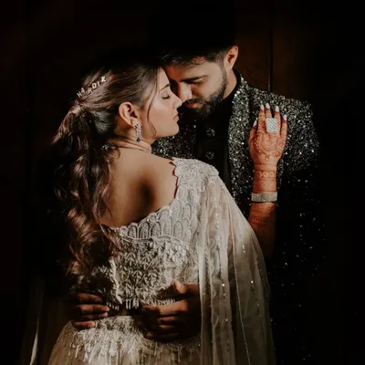 An intimate and moody portrait of a couple on their Sangeet night. I use shadows and focused light to create these dramatic, fine art photographs.