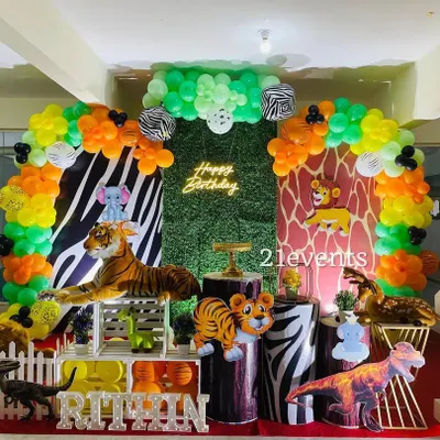 A full view of a vibrant jungle safari theme, complete with a neon sign, zebra and giraffe print backdrops, and plenty of animal props. This is one of my most detailed and budget-friendly packages.