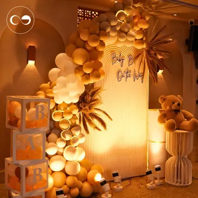 For a chic and modern celebration, I designed this boho themed baby shower. The warm, earthy tones of the balloon arch, combined with pampas grass and a glowing "Baby B On The Way" sign, created a sophisticated and dreamy ambiance.