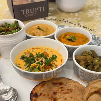 This is the heart of a Trupti wedding feast. A traditional Indian thali with a variety of subzis, dal, and hot roti, served with the elegance that defines our brand.