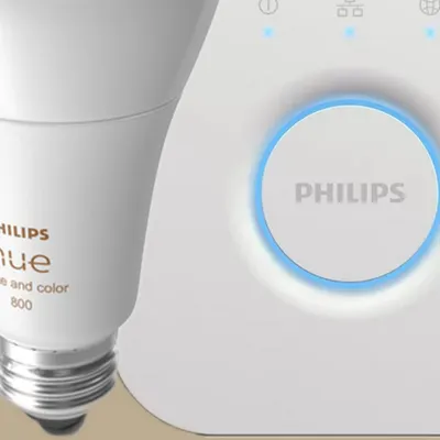 We integrate Philips Hue, the world's leading smart lighting brand. This image shows the core components: a Philips Hue smart bulb, which can produce millions of colors, and the Hue Bridge, which connects your lights to your smart home network.
