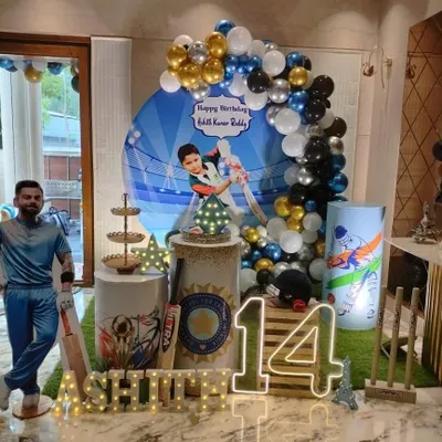 A cricket-themed birthday party for a 14-year-old, featuring a life-size cutout of a famous cricketer and a personalized backdrop.