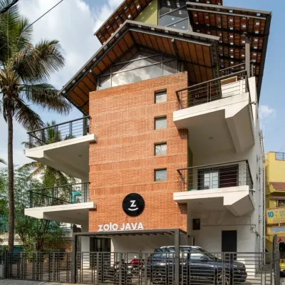 This is the completed exterior of the Earthen Spirit project, a warehouse we repurposed into a modern co-living space called Zolo Java. We added new balconies and a striking multi-layered roof structure, blending the building's industrial past with a fresh, residential feel. The final design stands as a testament to how adaptive reuse can revitalize urban structures.