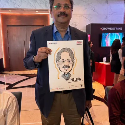 A guest at the Jio World Convention with his caricature. The drawing paper is co-branded with the event sponsor's logo, making it a great marketing tool.