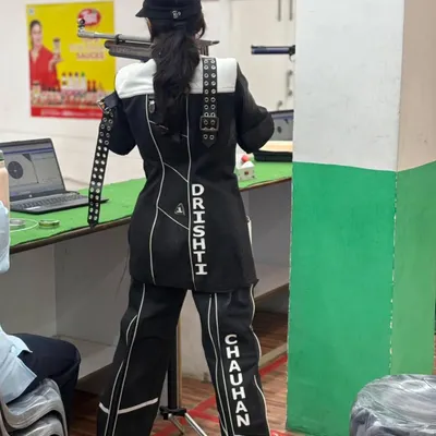 A rifle shooter in full gear, focused and ready during a competition. This is the result of countless hours of practice.