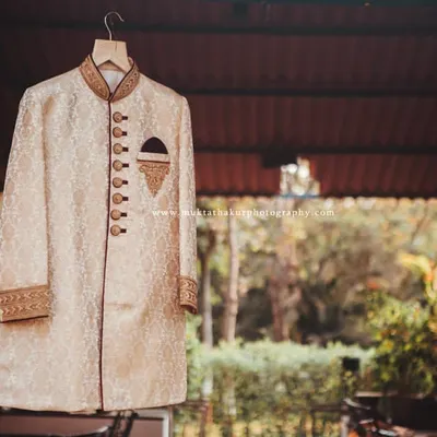 The groom's sherwani, hanging in anticipation of the big moment. I take care to photograph the wedding attire in a way that feels as grand as the day itself.