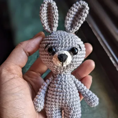 A tiny grey bunny keychain, small enough to fit in your hand but full of personality.
