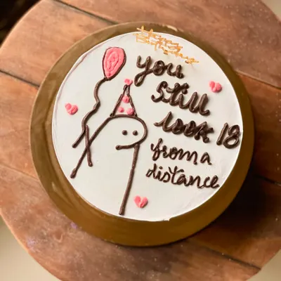 A hilarious birthday cake with a stick figure and the message, "you still look 18 from a distance." This custom cake is in my popular Nutella Ferrero Rocher flavor.