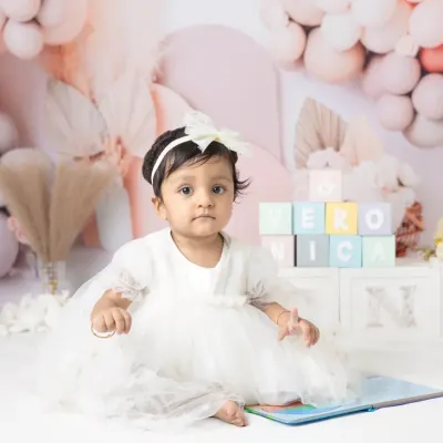 Celebrating one year with a beautiful pastel balloon setup. These milestone sessions are designed to be soft, dreamy, and perfect for a first birthday.
