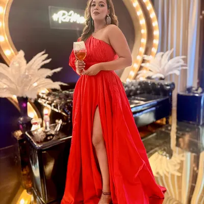 A red dress and a glass of wine. A perfect combination for a winter evening event.