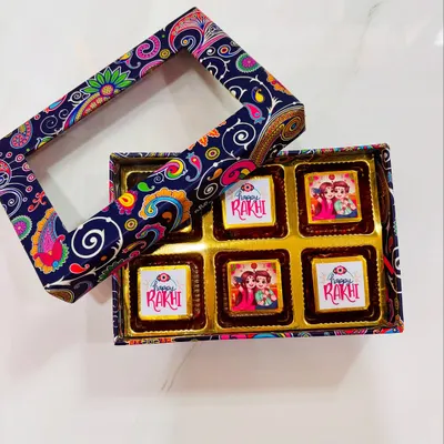 A box of my special Rakhi chocolates with custom-printed wrappers. This box features a beautiful paisley design and a clear window to see the festive treats inside, perfect for gifting to a brother or sister.