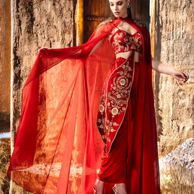 When light kisses crimson. This shot was framed to capture the motion of the sheer cape, the detail of the embroidery, and the elegance of the pose, all suspended in a single moment.