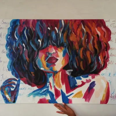 Holding up my large 3x2 ft abstract portrait. The piece uses bold, expressive strokes of color and has handwritten text in the background, adding another layer of meaning.