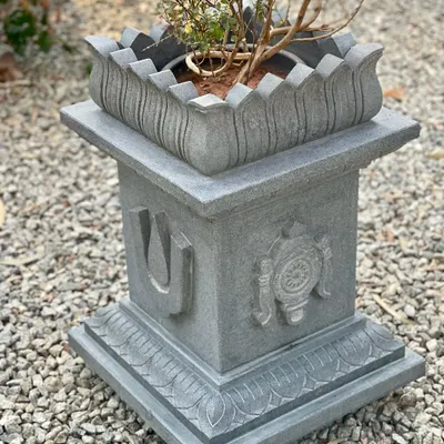 This large, temple-style Tulasi Brindavan is carved from black granite and features motifs of Lord Balaji. The 'kamala' (lotus) base and top create a beautiful cradle for the sacred Tulasi.