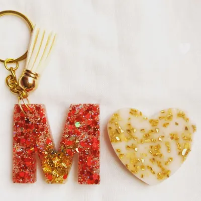 My initial keychains are one of my most requested items. This 'M' keychain is made with red glitter and gold leaf, paired with a matching heart charm.