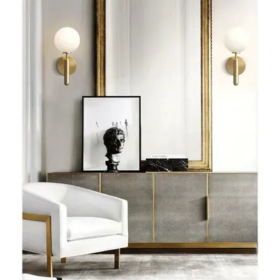 A perfect example of functional elegance, these modern globe sconces with a frosted finish provide soft, diffused light. Placed on either side of a mirror, they create a balanced and inviting vanity or entryway setting.